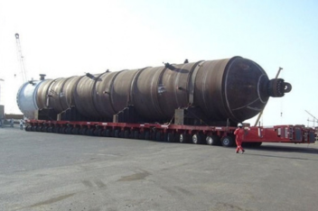 Large industrial machine secured on a low-bed trailer